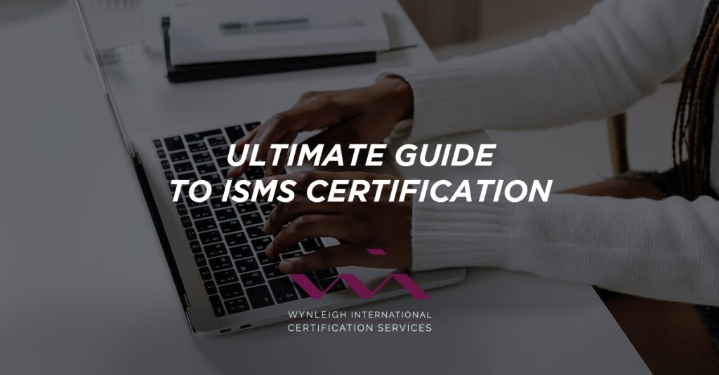 A banner image designed specifically for the Wynleigh International brand. The background image shows a business person working on a laptop. There is a text overlay that reads: "Ultimate Guide to ISMS Certification."