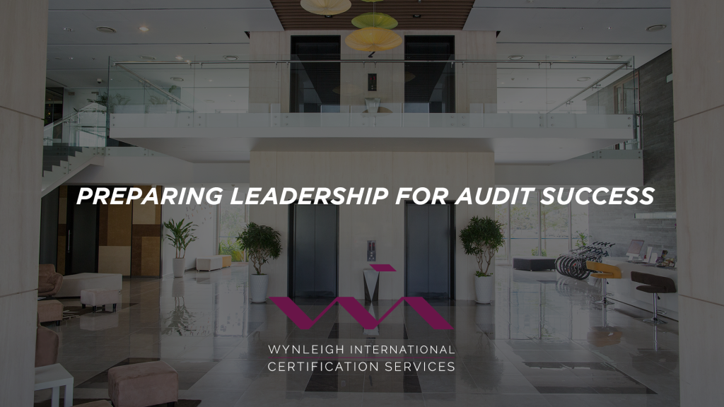A banner image designed for the Wynleigh International brand. The background image shows a daylight-filled, modern corporate environment. There is a text overlay that reads: "Preparing Leadership for Audit Success"